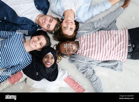 Top View Of A Diverse Group Of People Lying On The Floor And