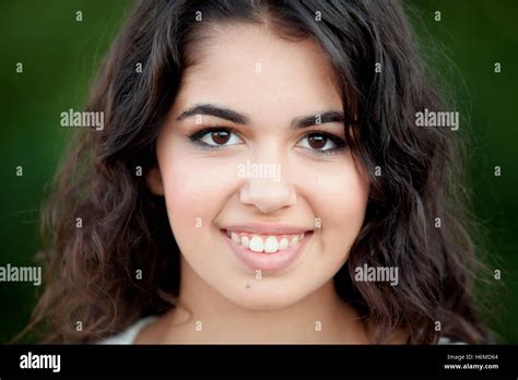 Beautiful Brunette Girl Relaxing In The Park Wiht Many Plants Of Background Stock Photo Alamy