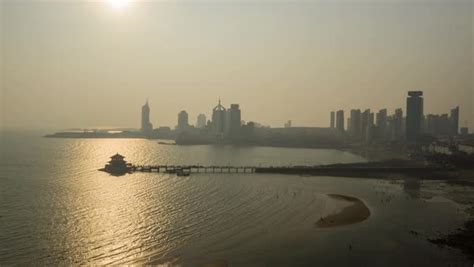 Sunset Flight Over Qingdao City Famous Palace By The Sea And Bay Pier