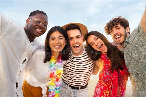 Happy Smiling Group Of Multiracial Friends Relaxing At The Beach