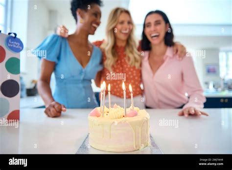 Three Mature Women Meeting At Home To Celebrate Friend S Birthday With Surprise Cake Together