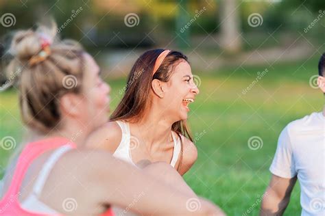 Selective Focus On A Woman Laughing While Sitting On A Park With Some