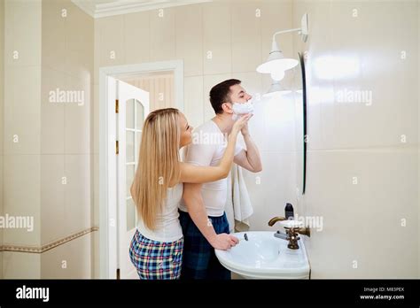 Couple In The Morning In The Bathroom Doing Personal Hygiene Romantic