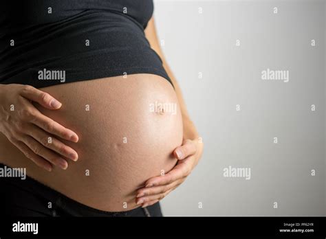 Closeup of pregnant belly in ninth month of pregnancy Stock Photo - Alamy