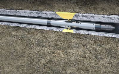 a large metal object laying on top of a cement floor next to a yellow ...