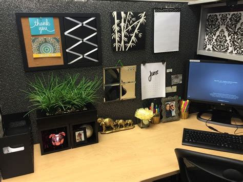 an office cubicle with desk, computer and plants on the wall above it ...