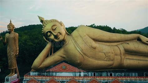 Aerial Of Golden Lying Sleeping Buddha Statue At A Buddhist Temple On