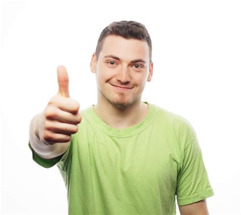 Premium Photo Young Man In Green Shirt Showing Thumbs Up