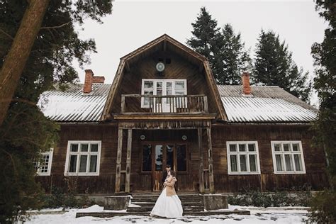 Premium Photo Gorgeous Bride In Coat And Stylish Groom Posing At