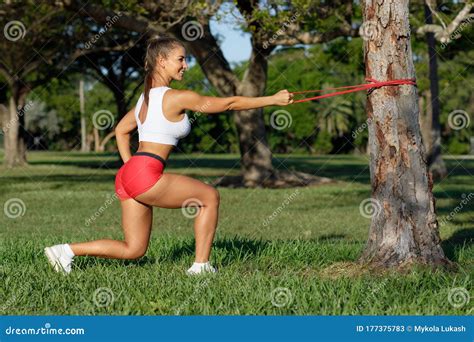 Athletic Woman Workout Squats With Resistance Band Outdoors Fitness