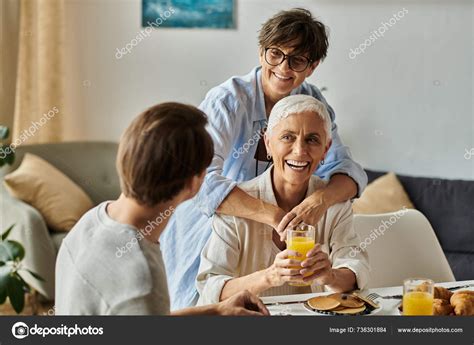 Loving Morning Gathering Lesbian Couple Adult Son Share Laughter Breakfast Stock Photo