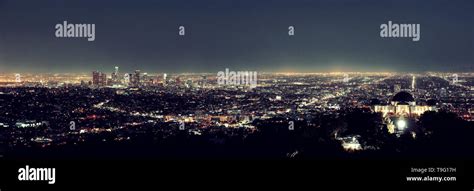 Los Angeles at night with urban buildings and Griffith Observatory ...