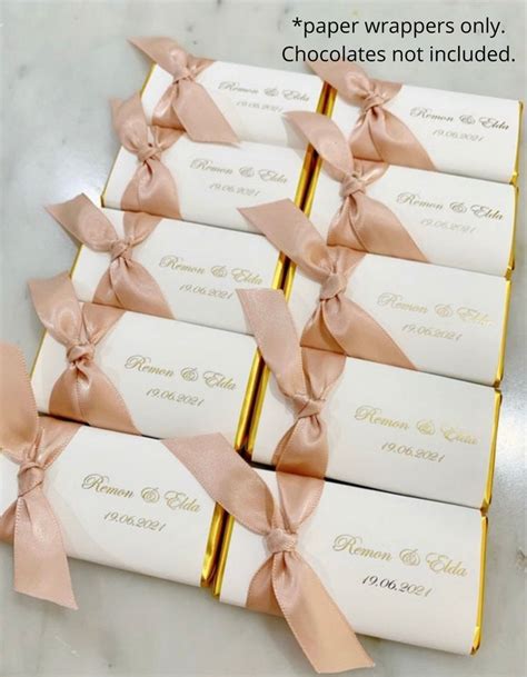 Six Wrapped Chocolates With Pink Bows On Them Are Sitting Next To Each Other And The Words Paper