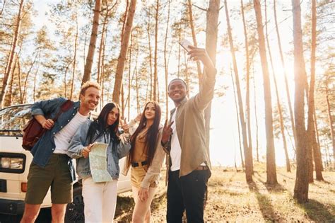 Premium Photo Making Selfie Group Of Young People Is Traveling Together In The Forest At Daytime