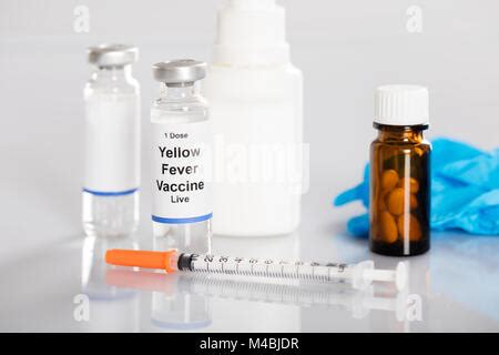 Yellow Fever Vaccine Bottle With Syringe Over Turquoise Background ...