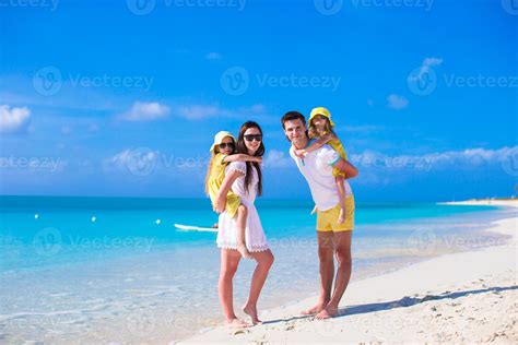 Young family of four on beach vacation 18047828 Stock Photo at Vecteezy