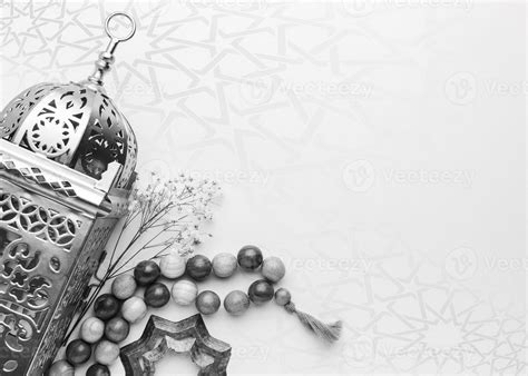 A black and white photo of a lamp and beads with copy space islamic ...