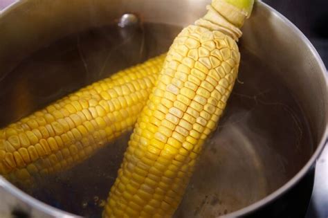 Premium Photo | Cooking boiled corn in boiling water closeup