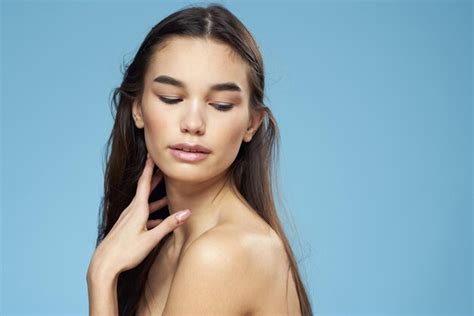 Premium Photo Woman With Naked Shoulders Long Hair Cosmetics Attractive Look Blue Background