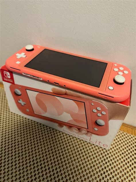 Nintendo Switch Lite Coral Video Gaming Video Game Consoles Nintendo On Carousell