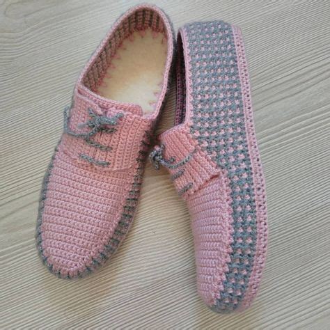 A Pair Of Pink Crocheted Shoes Sitting On Top Of A Wooden Floor