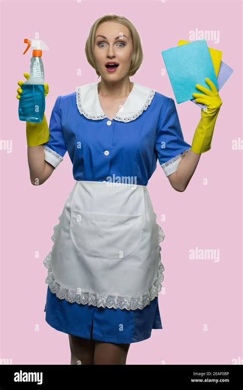 Full Sized Portrait Of Surprised Blonde Housekeeper Stock Photo Alamy