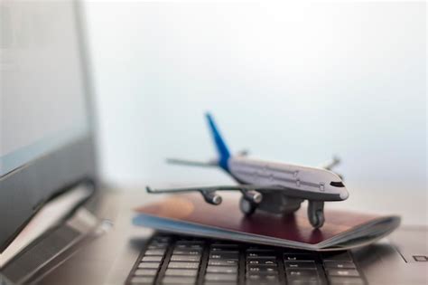 Premium Photo Close Up Of Model Airplane And Passport Over Laptop On