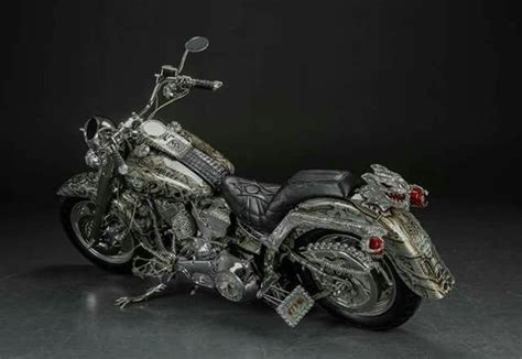 A Silver Motorcycle Parked On Top Of A Black Floor