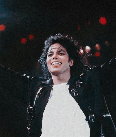 Michael Jackson Smiling And Holding His Arms In The Air While Standing