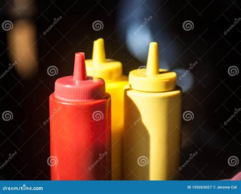 Three Plastic Bottles Red And Yellow Used For Fast Food Sauces Such