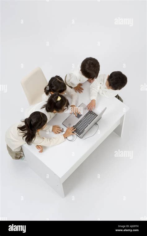 Five elementary age children using laptop Stock Photo - Alamy