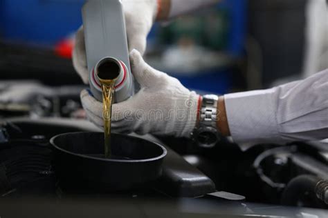 Worker Refueling And Pouring New Oil Into Engine Motor Car Stock Photo