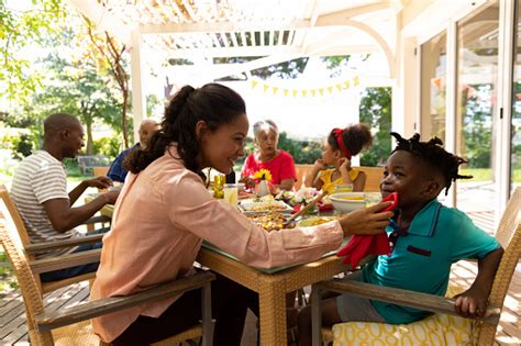 Family Eating Together At Table Stock Photo - Download Image Now - Cleaning, Human Face, Men ...