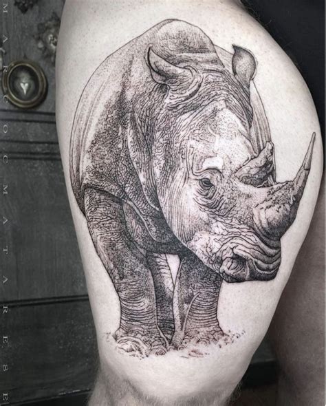 A Rhino Tattoo On The Back Of A Man S Thigh