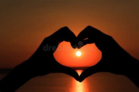 Silhouette of Hands in Form of Heart on Background of Sunset Stock ...