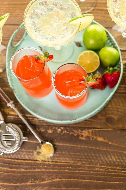 Premium Photo Classic Lime And Strawberry Margaritas On The Rocks