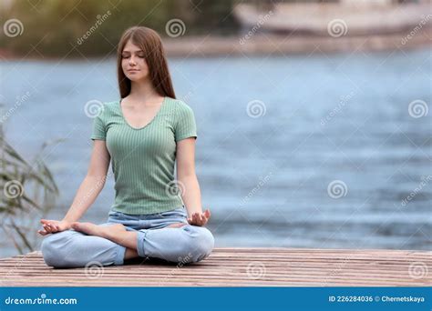 Teenage Girl Meditating Near River Stock Photo Image Of Pier Mental