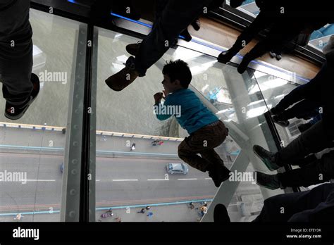 Visitors on the new glass floor in Tower Bridge. One of the bridge’s ...