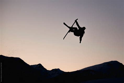 Silhouette Of Skier In Mid Air From The Big Jump Freestyle At Sunset