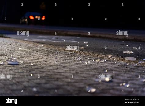 Ice Smashed On A Lantern Lit Sidewalk At Night Blurred Background With