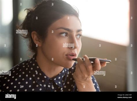 Indian Woman Recording Audio Message Or Using Voice Recognition Stock