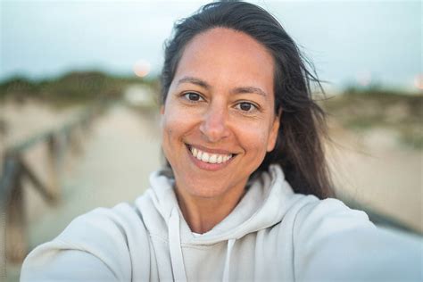 Ugc Selfie Of Tanned Young Woman On The Beach At Sunset By Stocksy