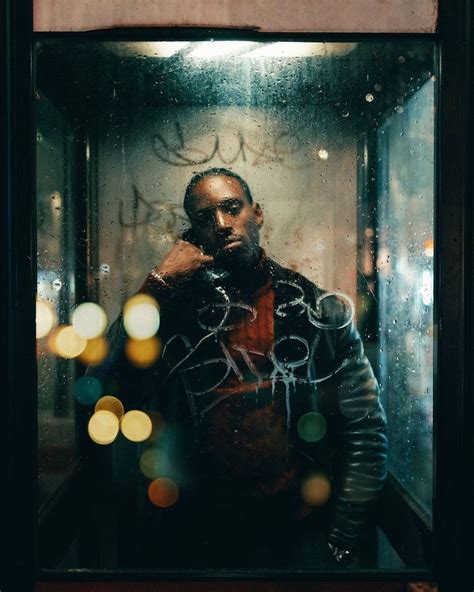 A Man Standing In Front Of A Window Covered In Graffiti And Writing On The Glass