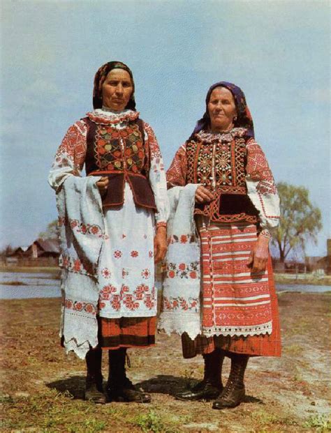 two women in traditional clothing standing next to each other on the ...