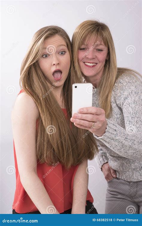Teenage Girl With Mature Woman With Phone Stock Photo Image Of Families Cellphone