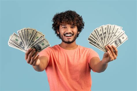 Premium Photo Happy Indian Man Holding Cash In Both Hands And Smiling