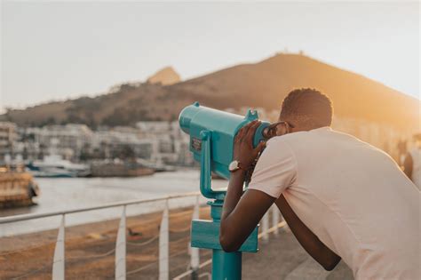 Gay Couple Embracing And Kissing Underneath The Rainbow Flag Authentic Stock Photos