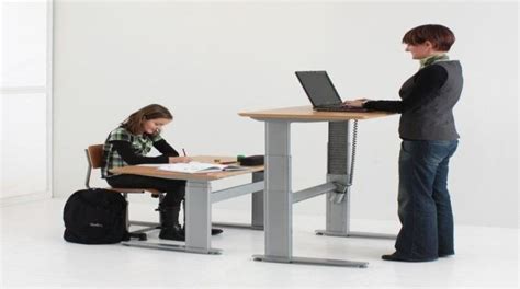 Student at Sitting Desk with Teacher at Standing Desk | Download ...