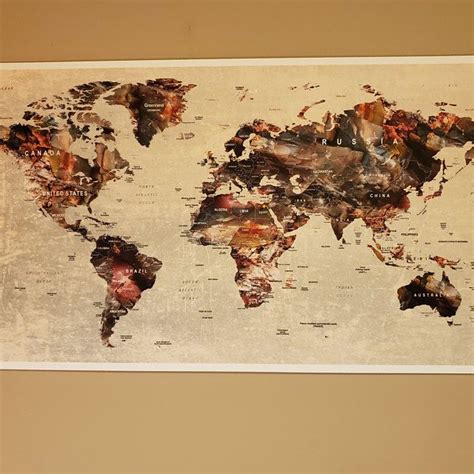 A Large Map Of The World Is Hanging On A Wall