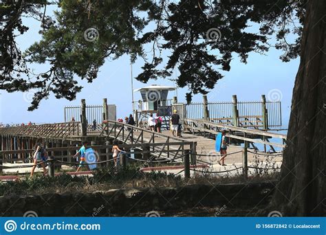 Tourists And Locals Enjoy The Walk On The Historic Wooden Pier At